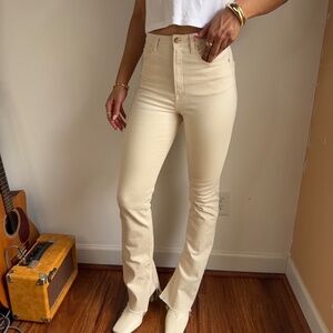 Cream high-waisted bootcut ZARA jeans with frayed hem